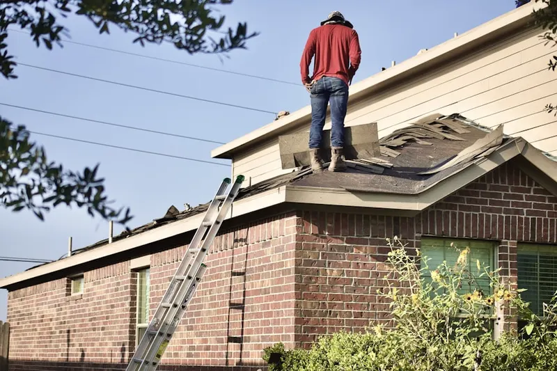 Professional roofer working on a residential roof in Sulphur
